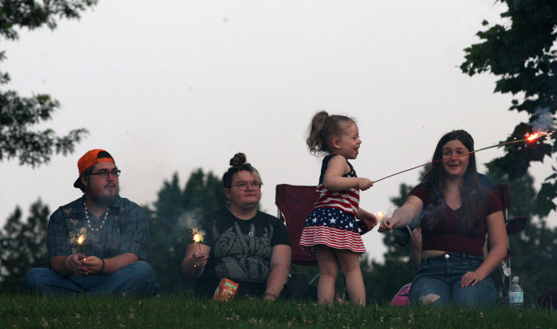 People hold sparklers